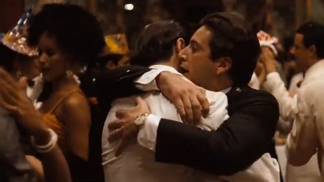 Michael hugging Fredo and whispering into his ear at a party in "The Godfather Part II"