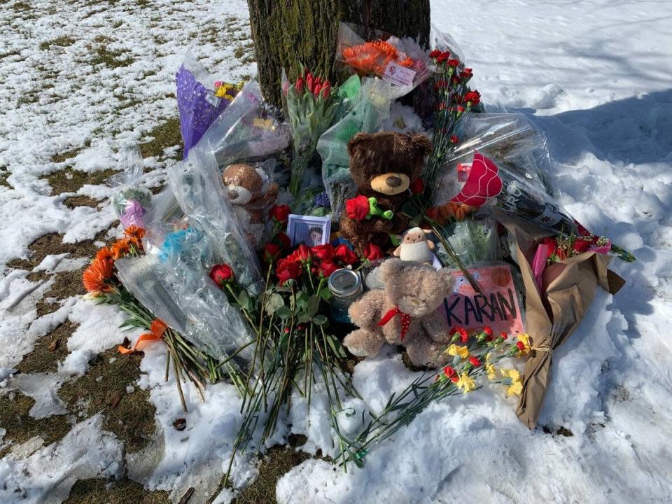 A memorial outside McNally High School continued to grow on Wednesday for 16-year-old Karanveer Sahota. (Julia Wong/CBC  - image credit)