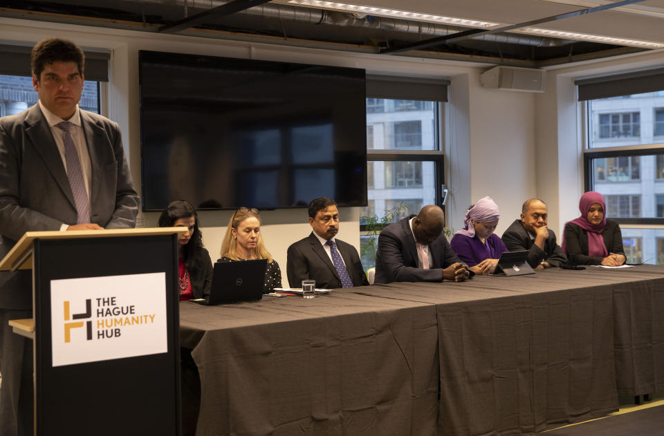 Members of a delegation of Gambia and others observe a minute of silence prior to the start of a press conference in The Hague, Netherlands, Monday Nov. 11, 2019, after the delegation filed a case at the International Court of Justice, the United Nations' highest court, in The Hague, accusing Myanmar of genocide in its campaign against the Rohingya Muslim minority. A statement released Monday by lawyers for Gambia says the case also asks the International Court of Justice to order measures "to stop Myanmar's genocidal conduct immediately." (AP Photo/Peter Dejong)