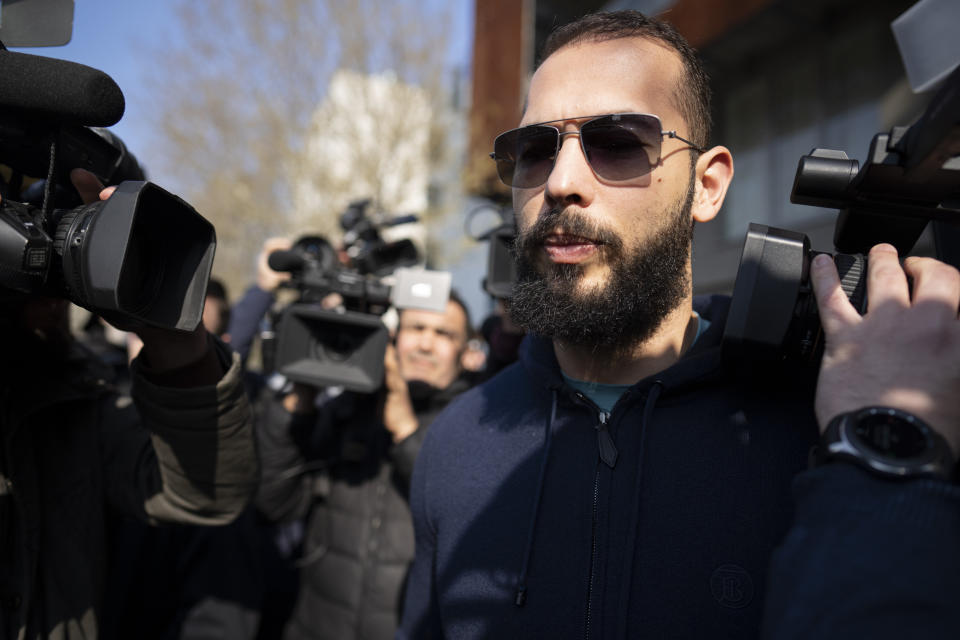 Andrew Tate leaves the Directorate for Investigating Organized Crime and Terrorism (DIICOT) where prosecutors examined electronic equipment confiscated during the investigation into his case, in Bucharest, Romania, Monday, April 10, 2023. (AP Photo/Vadim Ghirda)