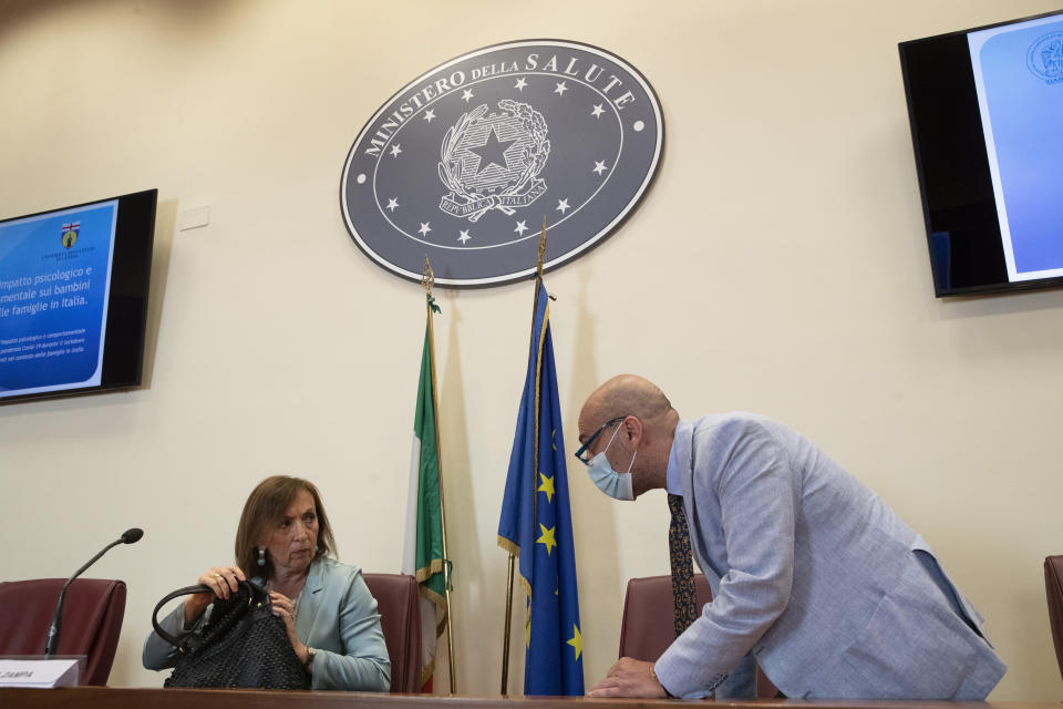 Sandra Zampa, Health Ministry Undersecretary, left, and psychiatrist Fabrizio Starace, arrive for a press conference at the Italian Health Ministry to present the results of an investigation on the psychological and behavioral impact the coronavirus lockdown has had on children and adolescents in Italy, in Rome, Tuesday, June 16, 2020. (AP Photo/Alessandra Tarantino)