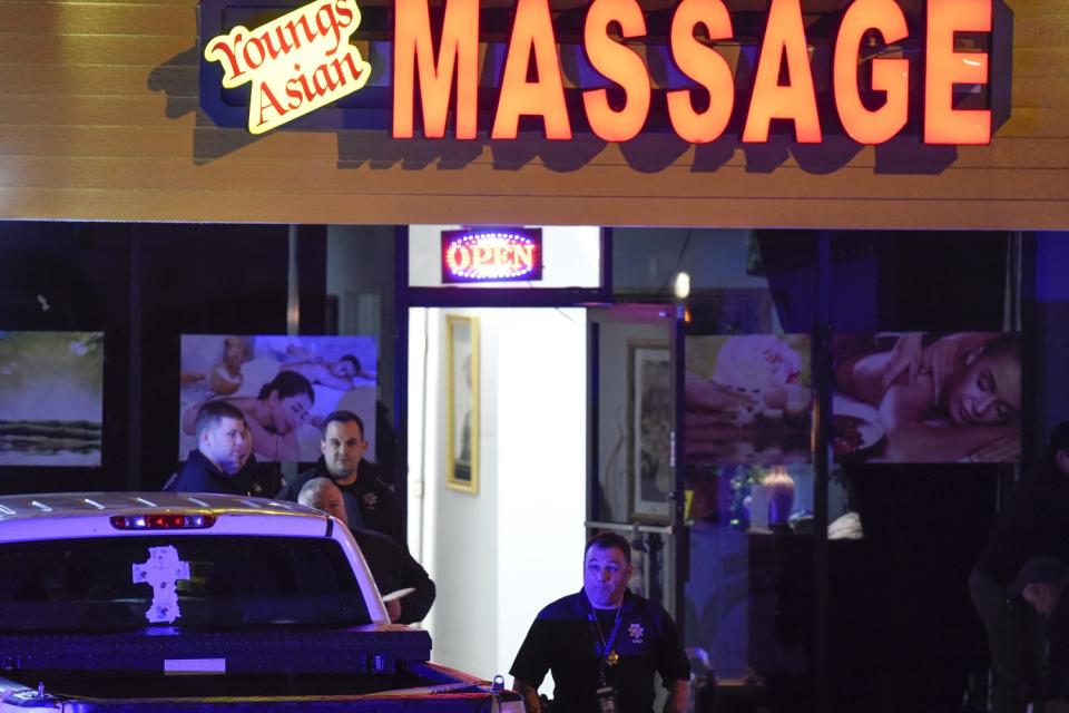 Police outside an Asian spa in a strip mall at night