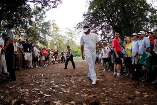 Bubba Watson of the United States looks at a shot from the rough on second sudden death playoff hole on the 10th during the final round of the 2012 Masters Tournament at Augusta National Golf Club in Augusta, Georgia
