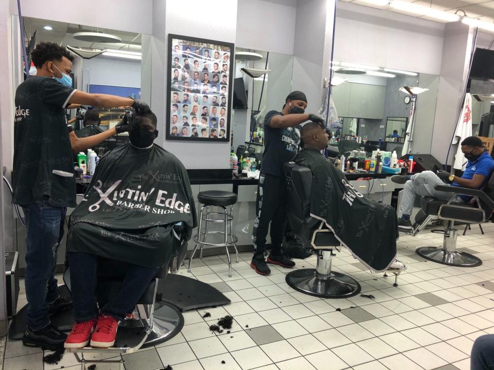 John James gets his hair cut at Kuttin' Edge barber shop in Houston's Galleria Mall.