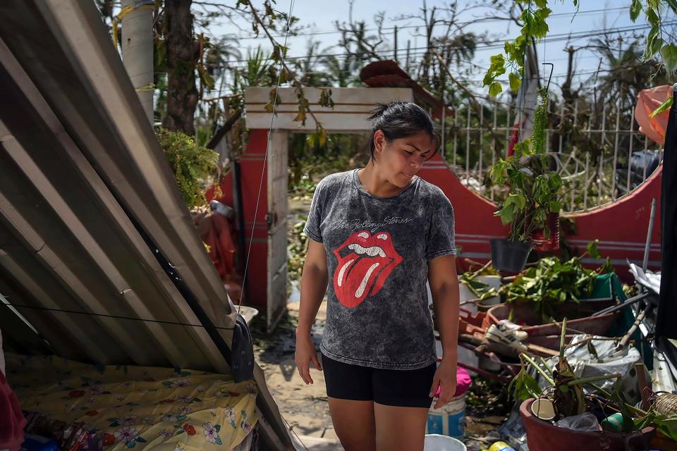 Jessika Dorantes stands in the home of her mother Estela Sandoval after it was destroyed by Hurricane Otis, as she helps to clean up, in Acapulco, Mexico, Friday, Oct. 27, 2023. Sandoval was among hundreds of thousands of people whose lives were torn apart when the fastest intensifying hurricane on record in the Eastern Pacific shredded the coastal city of 1 million.