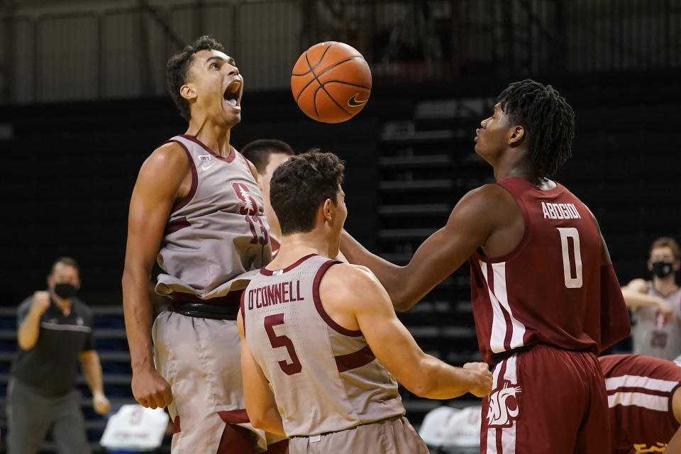 Stanford forward Oscar da Silva, left, celebrates after scoring and being fouled with teammate Michael O'Connell (5) in front of Washington State center Efe Abogidi (0) during the second half of an NCAA college basketball game in Santa Cruz, Calif., Saturday, Jan. 9, 2021. (AP Photo/Jeff Chiu)