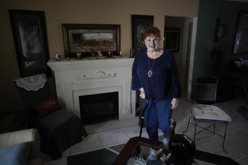 Deanna Dezern, 83, walks inside her home in Tamarac, Fla., Thursday, Dec. 7, 2023. Dezern is among the first in the country to receive the robot ElliQ, whose creators, Intuition Robotics, and senior assistance officials say is the only device using artificial intelligence specifically designed to lessen the loneliness and isolation experienced by many older Americans. (AP Photo/Rebecca Blackwell)