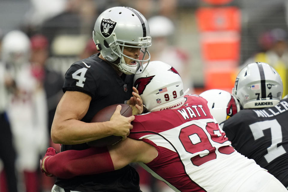 Las Vegas Raiders quarterback Derek Carr (4) is sacked by Arizona Cardinals defensive end J.J. Watt (99) during the first half of an NFL football game Sunday, Sept. 18, 2022, in Las Vegas. (AP Photo/John Locher)