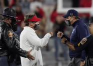 Georgia coach Kirby Smart, left, and Auburn coach Gus Malzahn, right, meet after an NCAA college football game Saturday, Oct. 3, 2020, in Athens, Ga. (AP Photo/Brynn Anderson)