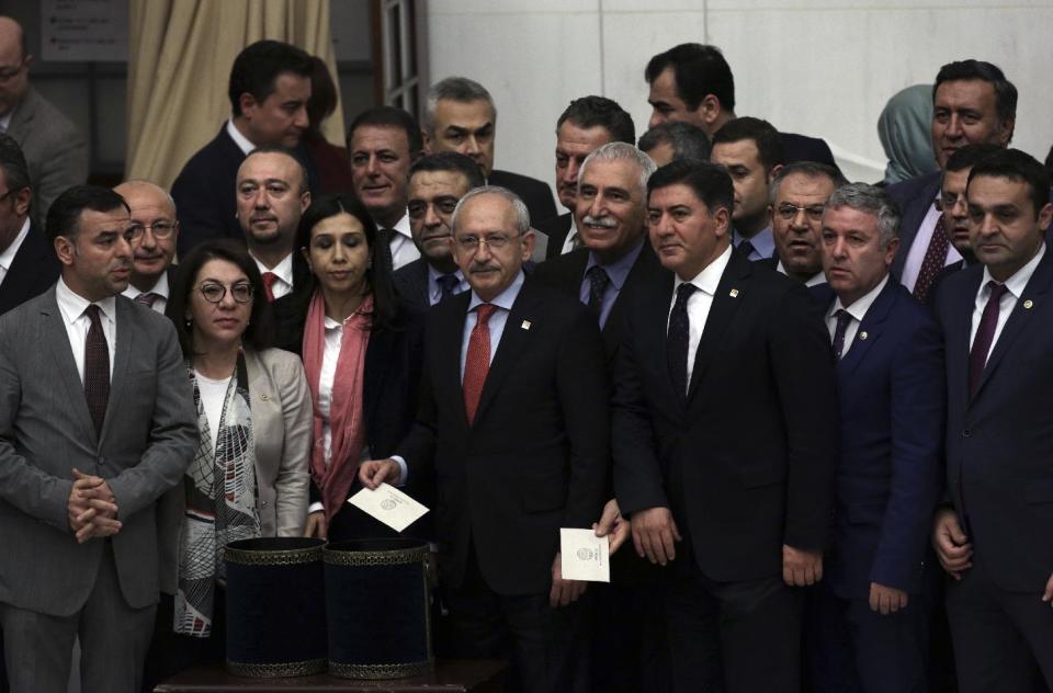 Turkey's main opposition Republican People's Party leader Kemal Kilicdaroglu, center, poses for a photo with his legislators shortly before Turkey's parliament approved a contentious constitutional reform package, paving the way for a referendum on a presidential system that would greatly expand the powers of President Recep Tayyip Erdogan's office, in Ankara, Turkey, early Saturday, Jan. 21, 2017. In an all-night session that ended early Saturday, lawmakers voted in favor of a set of amendments presented by the ruling party, founded by Erdogan.(AP Photo/Burhan Ozbilici)