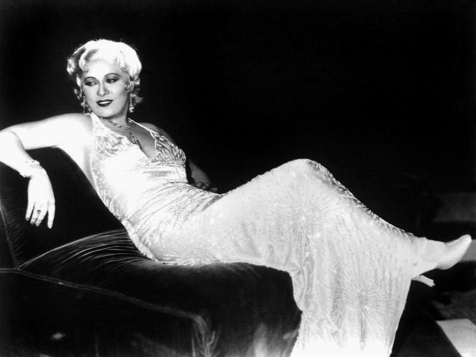 Mae West, seen lounging with her heels on, in a scene from the movie "Rebecca of Sunnybrook Farm"