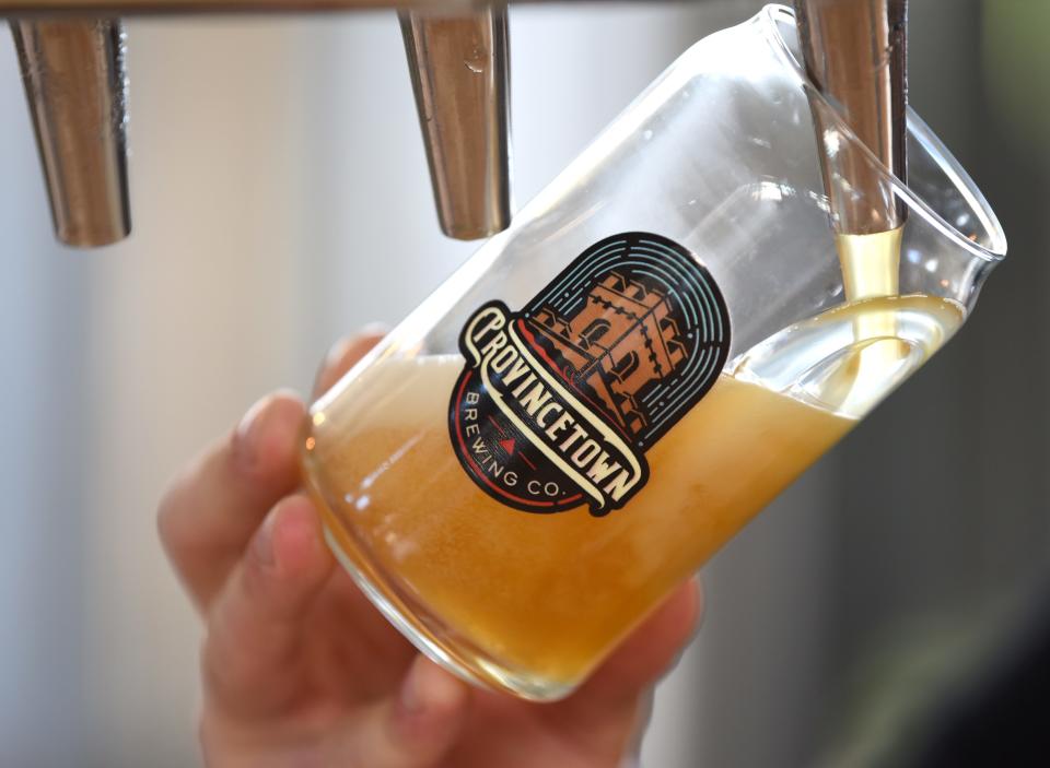 A drink is poured from the tap at Provincetown Brewing Co. in this 2019 photo.