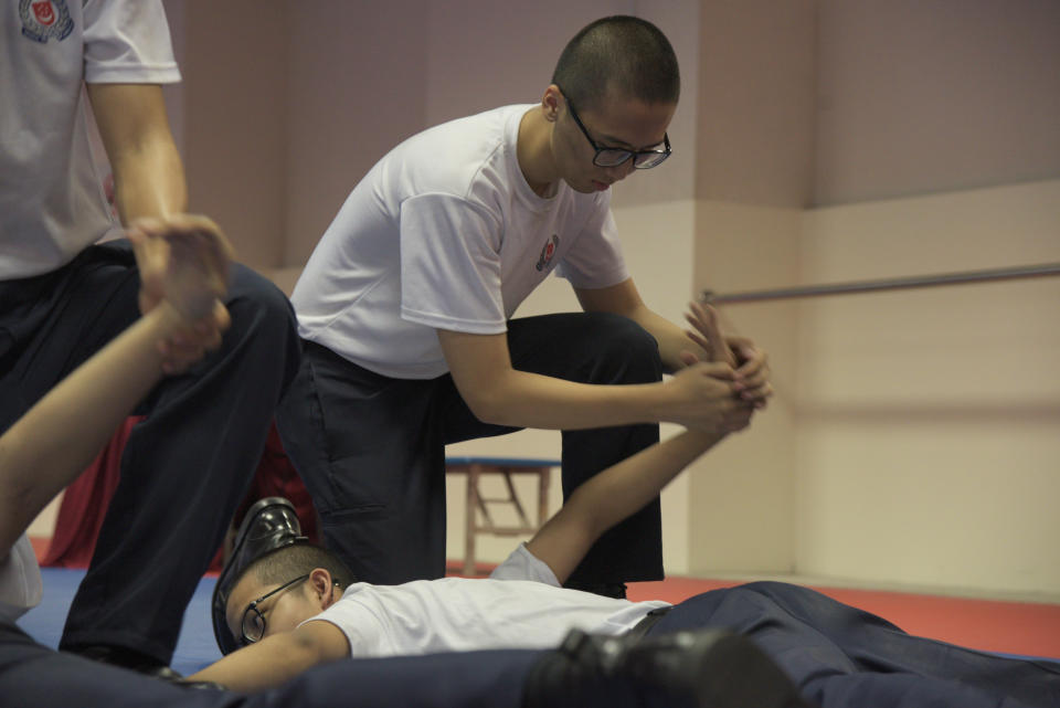 A national serviceman practices a takedown technique during his training at the Home Team Academy. Photo: Andre He for Yahoo News Singapore