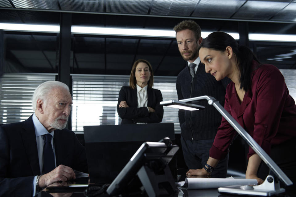 This image released by Peacock shows, from left, Christopher Plummer as Howard Lawson, Claire Forlani as Janet Freeh, Kris Holden-Ried as Dominic Hayes and Archie Panjabi as Kendra Malley in a scene from "Departure." Panjabi plays an aviation investigator and single mom who is called in to solve the strange disappearance of a jetliner en route to London in the six-part series premiering on Sept. 17 on the Peacock streaming platform. (Shaftesbury/Greenpoint Productions/Peacock via AP)