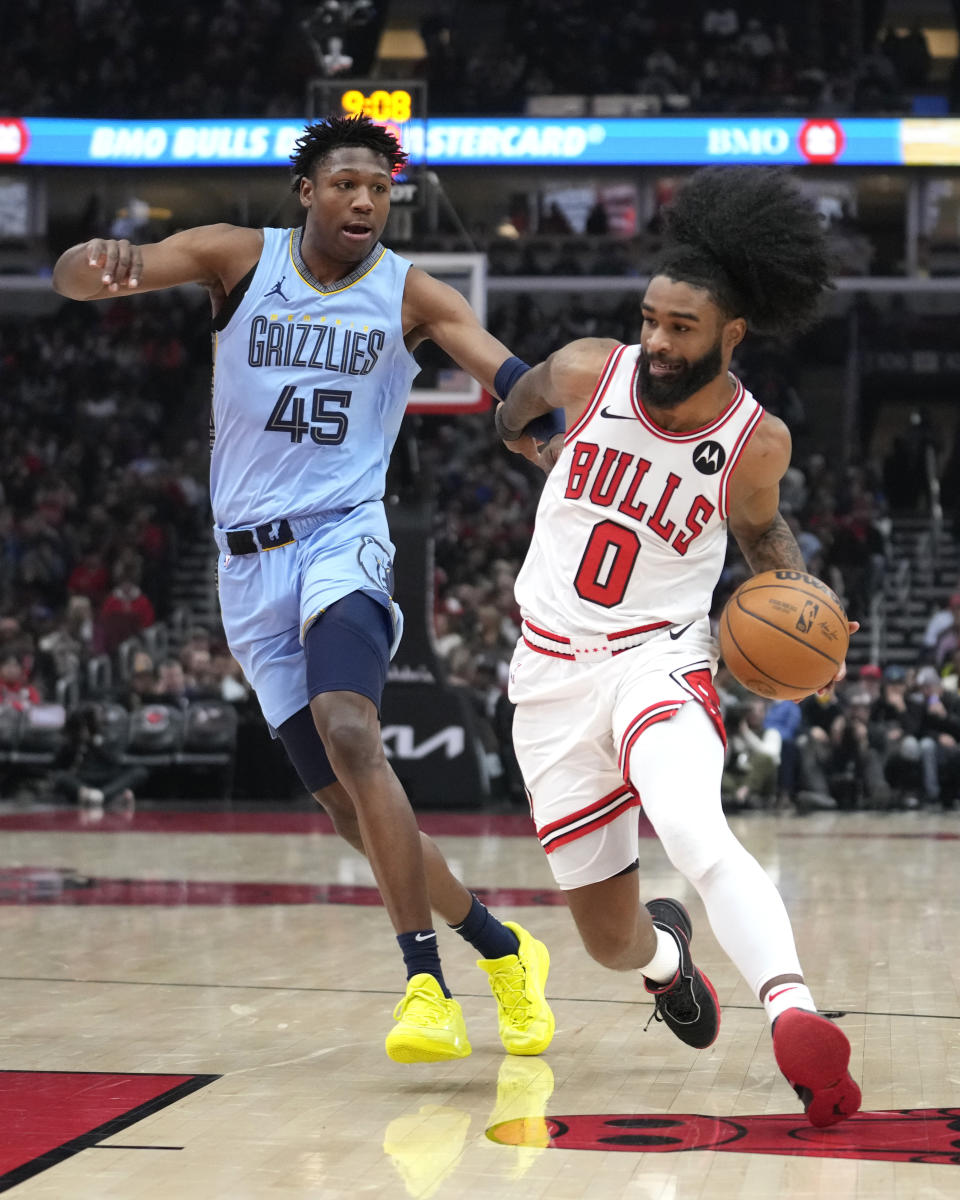 Chicago Bulls' Coby White (0) drives to the basket past Memphis Grizzlies' GG Jackson during the first half of an NBA basketball game Saturday, Jan. 20, 2024, in Chicago. (AP Photo/Charles Rex Arbogast)