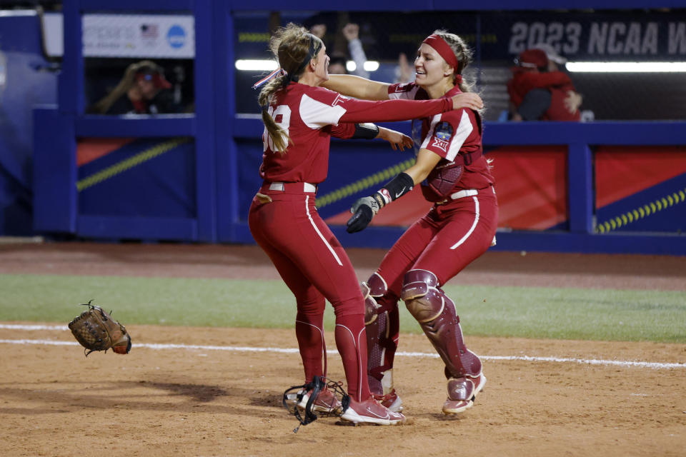 Oklahoma pitcher Jordyn Bahl, left, and catcher Kinzie Hansen celebrate the team's win over Florida State in the NCAA Women's College World Series softball championship series Thursday, June 8, 2023, in Oklahoma City. (AP Photo/Nate Billings)