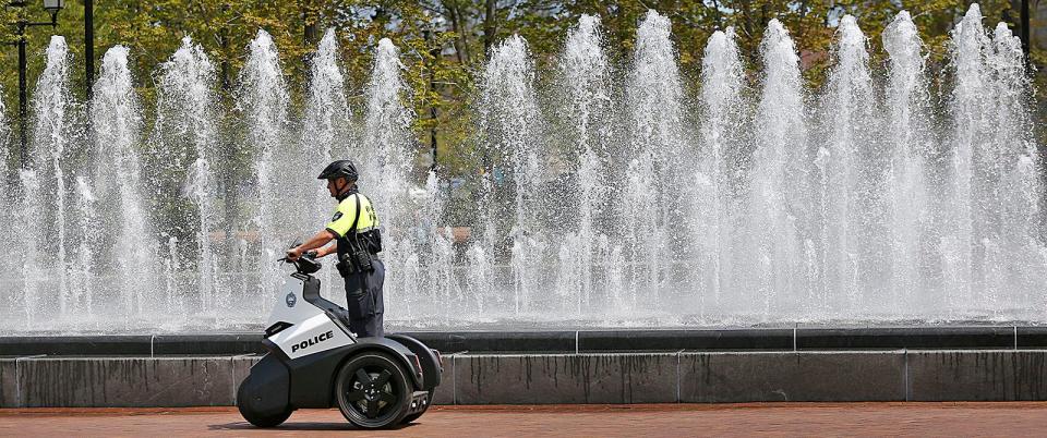 Quincy police officer Greg Hartnett patrols the Hancock-Adams Common in Quincy Square using a Segway scooter on Monday, May 3, 2021.