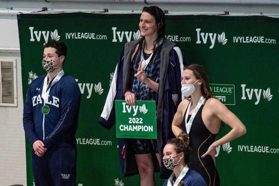 Trans swimmer Lia Thomas pose after winning the 100-yard freestyle race at the 2022 Ivy League Women’s Swimming & Diving Championship. AFP via Getty Images