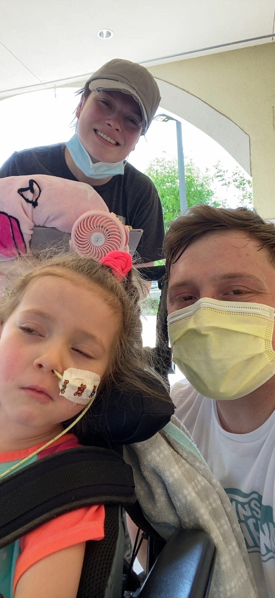 Lylah Baker continues to recover from melioidosis. She is with her parents, Josy and Dustin, on Monday at a rehabilitation hospital in Dallas.