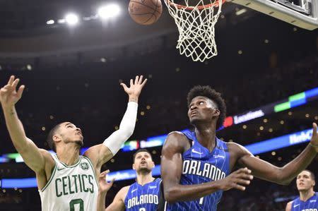 Oct 22, 2018; Boston, MA, USA; Boston Celtics forward Jayson Tatum (0) and Orlando Magic forward Jonathan Isaac (1) battle for a loose ball during the second half at TD Garden. Mandatory Credit: Bob DeChiara-USA TODAY Sports