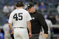 Third base umpire Bill Miller, right, stop inspect New York Yankees starting pitcher Gerrit Cole, left, for foreign substances after the top of the third inning of a baseball game against the Kansas City Royals, Tuesday, June 22, 2021, at Yankee Stadium in New York. (AP Photo/Kathy Willens)