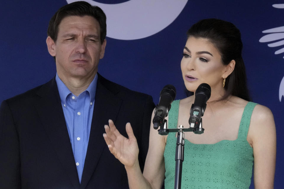 Florida Gov. Ron DeSantis, left, looks on as his wife Casey DeSantis speaks at a campaign event in Bluffton, S.C., on Friday, June 2, 2023. On the heels of his official campaign launch, DeSantis has been visiting the early voting states of Iowa, New Hampshire and South Carolina this week. (AP Photo/Meg Kinnard)