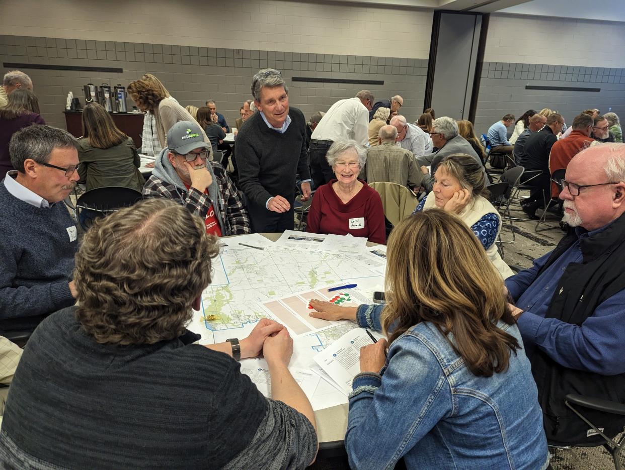 Jamie Greene, principal of Planning NEXT and leader of the consultant team, center, speaks to a community members during a Framework community workshop March 29 in the John Gilbert Reese Center on the Ohio State University at Newark campus.