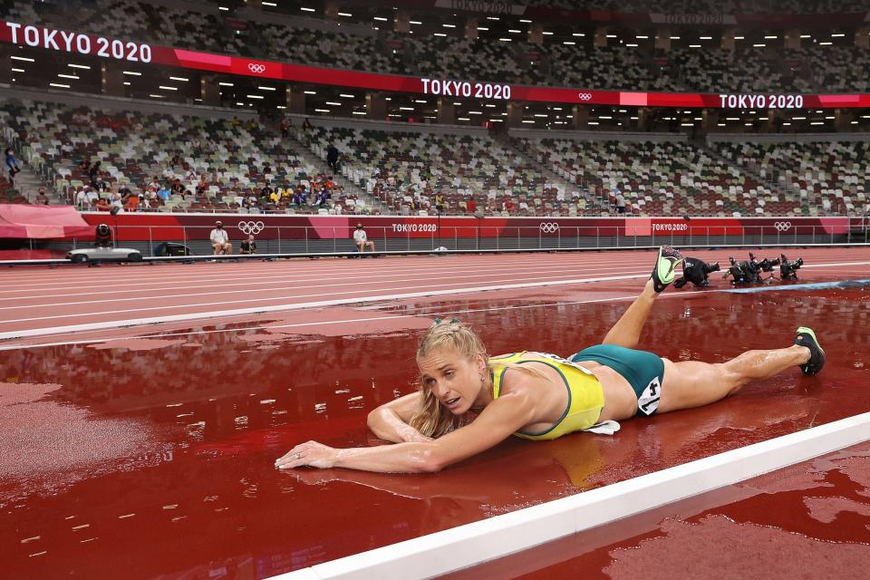 Genevieve Gregson of Team Australia lays injured during the 3000m steeplechase final at the Tokyo Olympics.