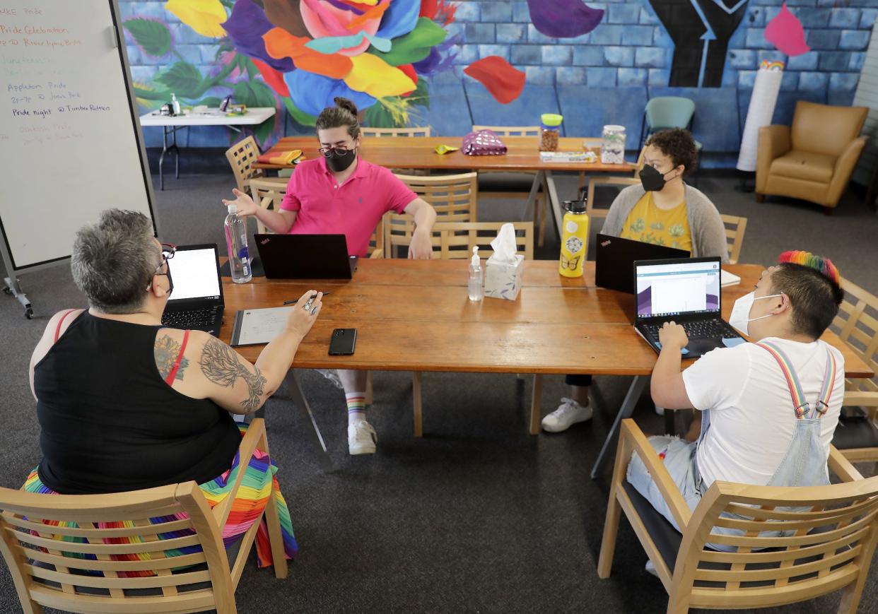 Kathy Flores, from left, Nick Ross, Keira Kowal Jett and Reiko Ramos work during a Diverse + Resilient staff meeting on Thursday, June 9, 2022 in Appleton, Wis.