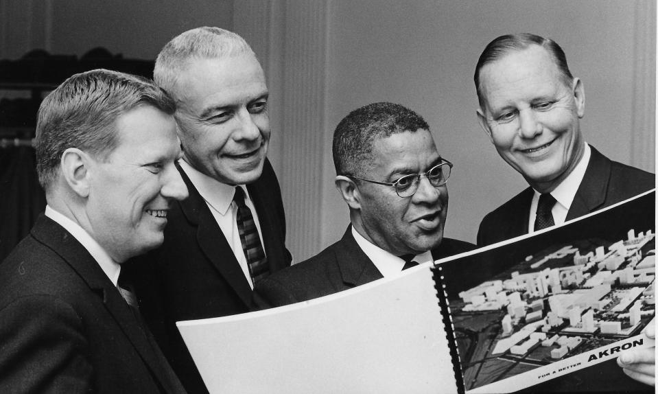 Studying a 1965 Akron revival plan are Robert W. Fischer, a Minneapolis banker; Gilbert V. Kullgren, co-founder of Hale and Kullgren; the Rev. Stanley E. Lynton, pastor of Second Baptist Church; and Vincent H. Johnson, president of Akron, Canton & Youngstown Railroad.