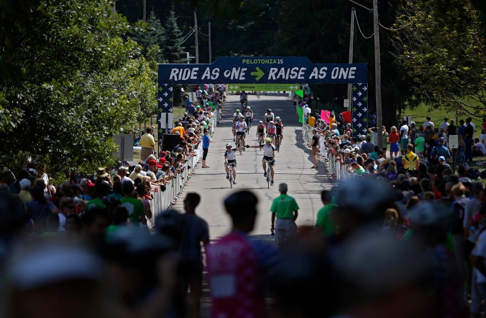 Riders cross the finishing line in Gambier on the 100 mile route during the 2015 Pelotonia.