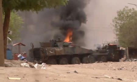 A still image taken from a video shows an armoured personnel carrier on fire after a car bomb attack in Gao, northern Mali July 1, 2018. REUTERS/via Reuters TV