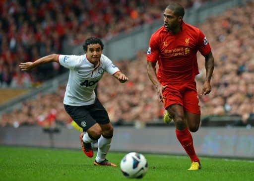 Liverpool defender Glen Johnson (R) runs with the ball during their English Premier League match against Manchester United on September 23. Liverpool suffered a 2-1 defeat by arch-rivals Manchester United at Anfield on Sunday