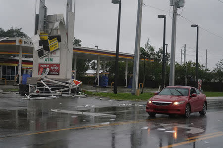 A gas station sign lays destroyed after Hurricane Irma blew though Fort Lauderdale, Florida, U.S., September 10, 2017. REUTERS/Carlo Allegri