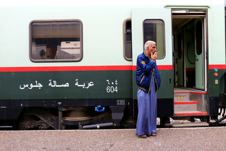 A passenger smokes a cigarette in a platform before boarding a train to Fallujah, the newly resurrected service to the city, at a railway station in Baghdad, Iraq November 7, 2018. Picture taken November 7, 2018. REUTERS/Thaier al-Sudani