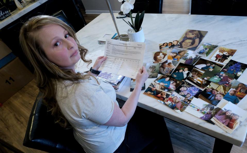 Theresa Sari looks over complaints in her Carteret, NJ, home Wednesday, April 20, 2022, that she filed over the nursing home care that was given to her mother.  Her 60-year-old mother died of COVID in a Long Island nursing home. 