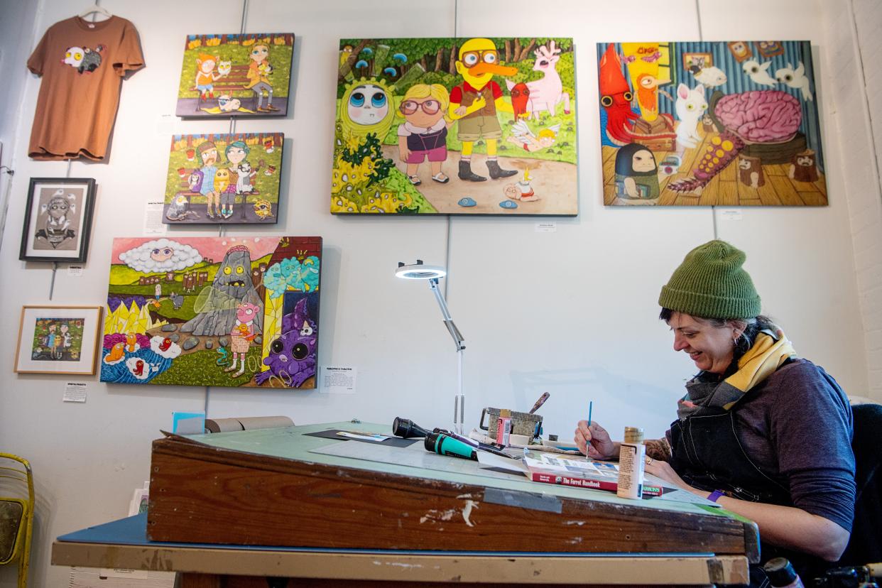 Artist Julie Armbruster works on a piece at Wedge Studios in the River Arts District in Asheville, March 4, 2024.