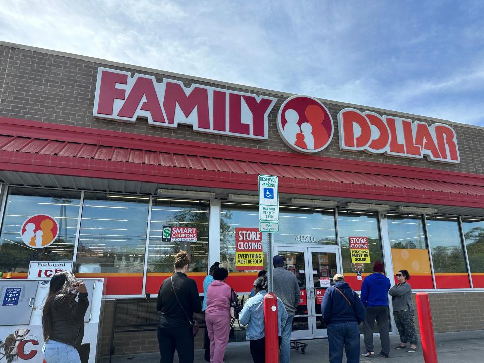 Customers line up outside the Family Dollar located on Carolina Beach Road for the store's 50% off closing sale. One customer said the store was letting in five people at a time each for 20 minutes to purchase items.