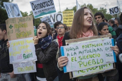 Protesters attend an anti-government demonstration near the parliament building in Madrid. Thousands of protesters rallied again Saturday in Spain, where the government submitted an austerity budget and said the public debt and deficit are set to rise far above earlier forecasts