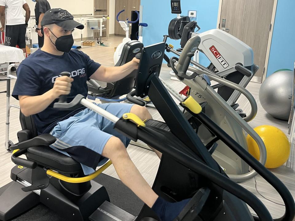 Rich Rotella on a bike machine during his rehab from limb-lengthening surgery.