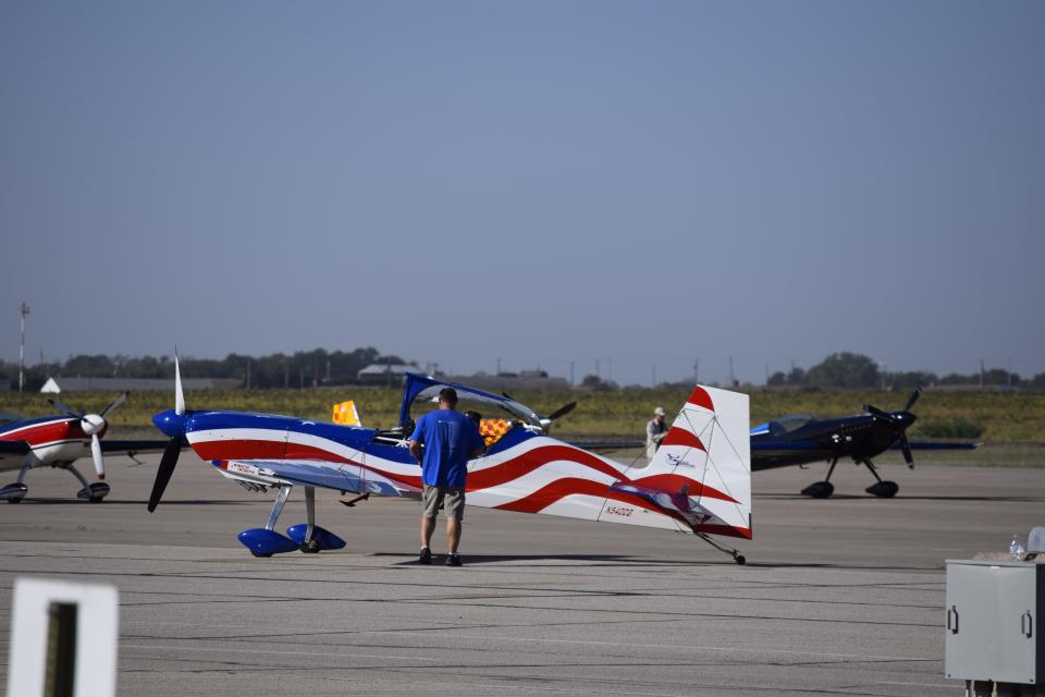 A Staudacher S-300D, painted in red, white and blue, sits on the tarmac at the Salina Regional Airport after flying a competition sequence for the 2023 U.S. National Aerobatic Championships.