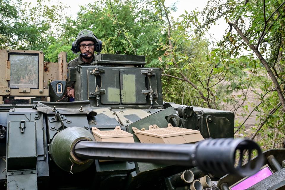 Gunner 'Molfar', 39, a Bradley IFV crew member of the 47th Magura Mechanized Brigade who took part in the fighting to liberate Robotyne village from Russian invaders, stands in the hatch of the vehicle in the southeastern Zaporizhzhia direction.