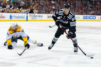 New Jersey Devils defenseman Kevin Bahl (88) is pursued by Nashville Predators left wing Kiefer Sherwood (44) during the second period of an NHL hockey game in Newark, N.J., Sunday, April 7, 2024. (AP Photo/Peter K. Afriyie)