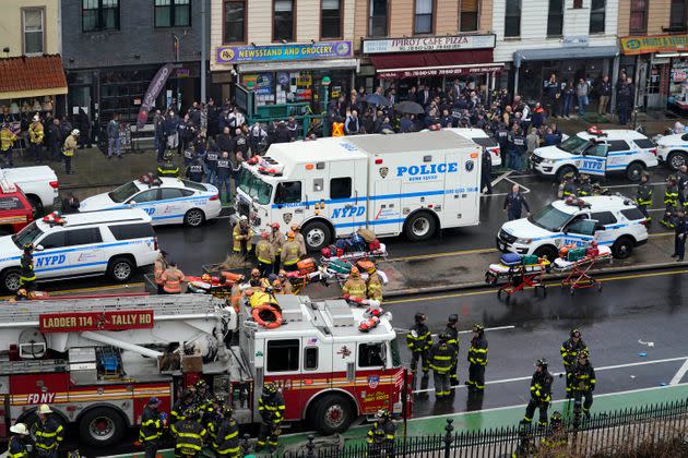 Emergency personnel gather at the entrance to a subway stop in Brooklyn. (Photo: John Minchillo via Associated Press)