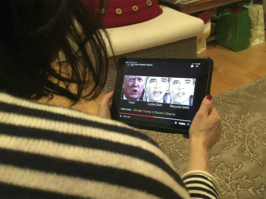 A woman in Washington, DC, views a manipulated video on January 24, 2019, that changes what is said by President Donald Trump and former president Barack Obama, illustrating how deepfake technology can deceive viewers. - "Deepfake" videos that manipulate reality are becoming more sophisticated and realistic as a result of advances in artificial intelligence, creating a potential for new kinds of misinformation with devastating consequences: Credit: ROB LEVER/AFP via Getty Images