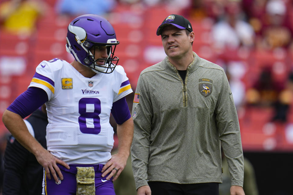 Minnesota Vikings quarterback Kirk Cousins (8) talking with Vikings head coach Kevin O'Connell before the start of an NFL football game against the Washington Commanders, Sunday, Nov. 6, 2022, in Landover, Md. (AP Photo/Julio Cortez)