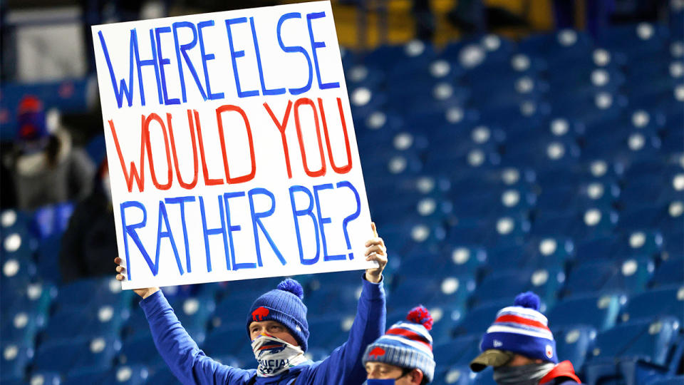 A Buffalo Bills fan holds up a sign in a near empty stadium during the Covid-19 pandemic.