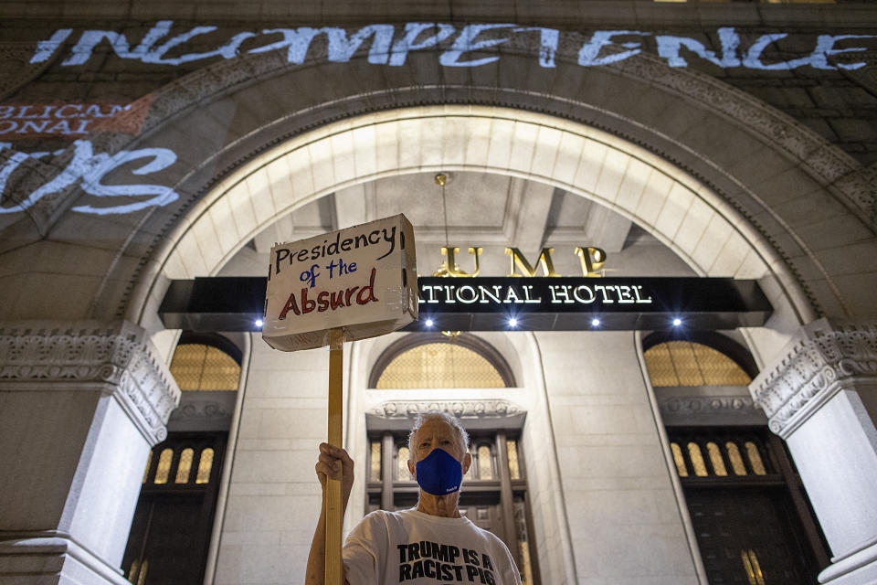 A protester stands outside the Trump International Hotel in Washington this summer. (Photo: Tasos Katopodis via Getty Images)