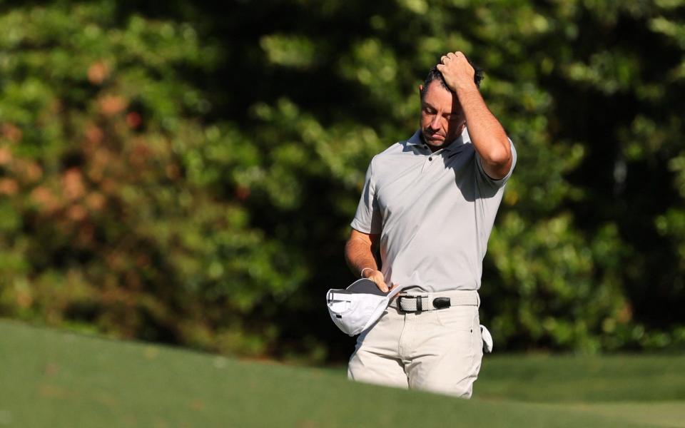 Northern Ireland's Rory McIlroy reacts as he walks off the green after a double bogey