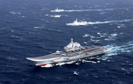 FILE PHOTO: China's Liaoning aircraft carrier with accompanying fleet conducts a drill in an area of South China Sea, in this undated photo taken December, 2016. REUTERS/Stringer/File photo